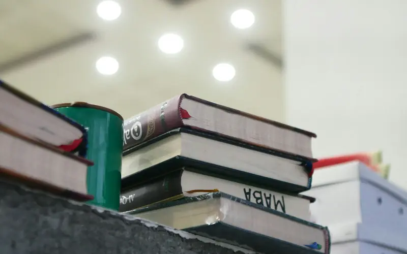 A stack of Islamic books in a mosque.